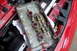 1997 Ford Probe - The removed valve cover shows internal engine components and oil residue, with a Ford logo visible on the engine block.