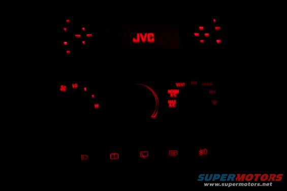 Car interior dashboard with red LED lights and JVC radio display