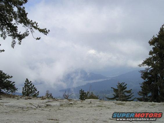Mountain landscape with clouds and trees, Supermotors.net logo