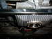1964 Volkswagen Beetle - Close-up of the underside of a vehicle's drivetrain, showing the transmission and driveshaft.