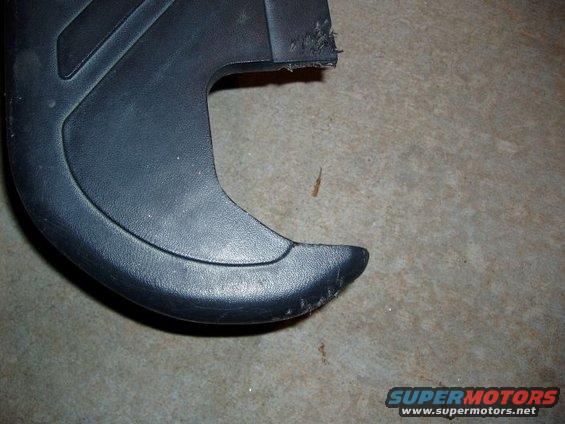 black plastic trim piece with frayed edge