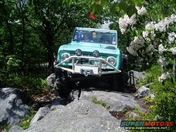 Teal 1969 Ford Bronco with winch on rocky trail