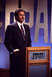 2002 Ford Taurus - Will Ferrell portrays Alex Trebek on the set of Jeopardy!, standing at a podium with the show's logo visible.