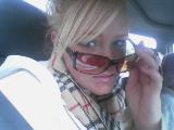 woman in sunglasses and scarf inside a vehicle