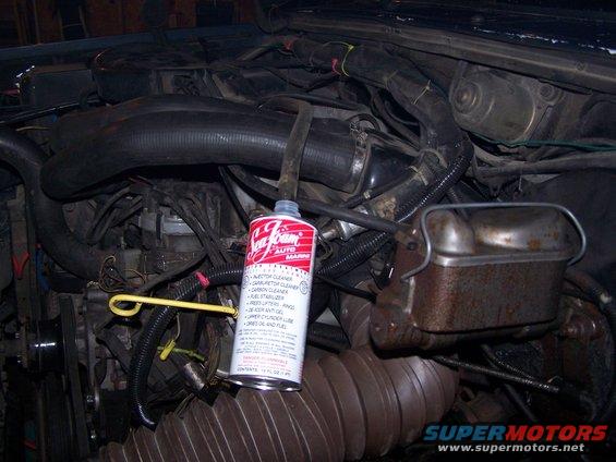 Engine bay with Sea Foam can. Rusty brake fluid reservoir