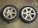 2004 Ford Focus - Two aftermarket wheels and tires are shown on a concrete surface.