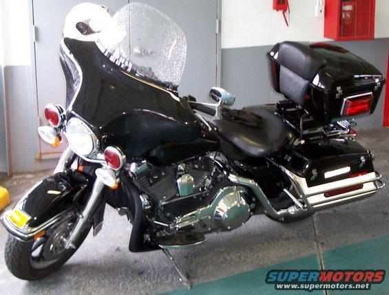 Black police motorcycle, 3q-front view, with large windshield and saddlebags