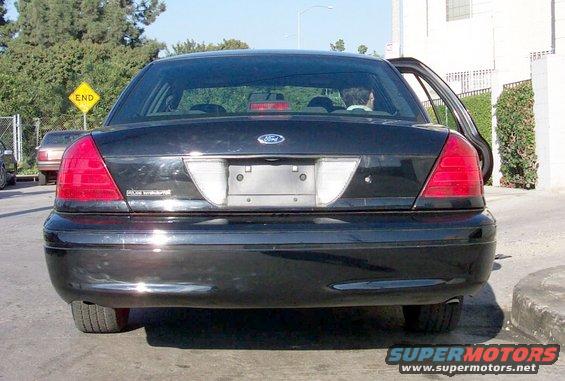 Rear view of a black 2003 Ford Crown Victoria with its driver's side door open