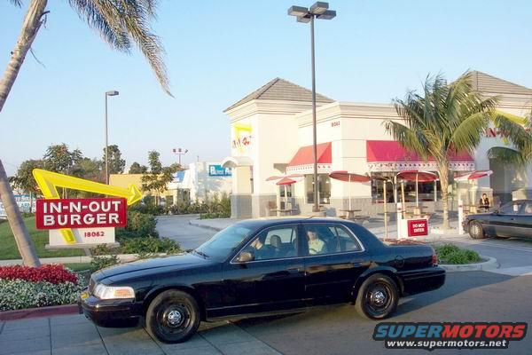 Black 2003 Ford Crown Victoria parked in front of In-N-Out Burger