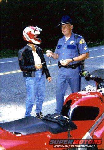 Red motorcycle part with a police officer and a helmeted person