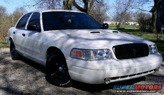White 2001 Ford Crown Victoria with black grille and hood scoops, parked outdoors