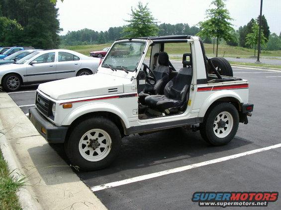 White 1988 Suzuki Samurai convertible with doors removed, parked in a lot