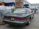 1996 Ford Crown Victoria - Rear view of a 1996 Ford Crown Victoria sedan parked in an industrial area.