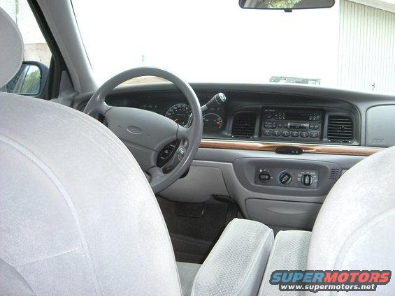 Interior view of a car's dashboard, steering wheel, and seats