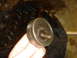 1986 Ford Mustang - A close-up of a metal component, possibly a bearing or pulley, held in a person's hand.