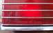 1985 Ford Crown Victoria LTD - A close-up of a red taillight assembly, showing embossed text and the Ford logo, suggesting a 1983 model year.