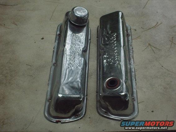 Pair of chrome valve covers with 'Edelbrock' script. One has a red gasket visible