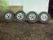 1979 Ford Bronco - Four tires and rims are displayed for sale, not a 1979 Ford Bronco.