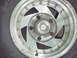 1979 Ford Bronco - This image shows a close-up view of a silver alloy wheel and a portion of a black tire, likely from a truck or SUV.
