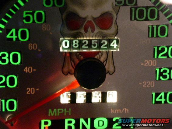 Speedometer gauge with skull graphic, showing 082524 miles and 5556 miles