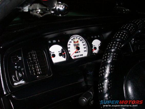 2001 Ford Crown Victoria interior showing custom white gauges with skull graphics and a black steering wheel with white dots
