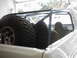 1978 Ford Bronco - Interior view of a 1978 Ford Bronco with a roll cage and spare tire mounted.