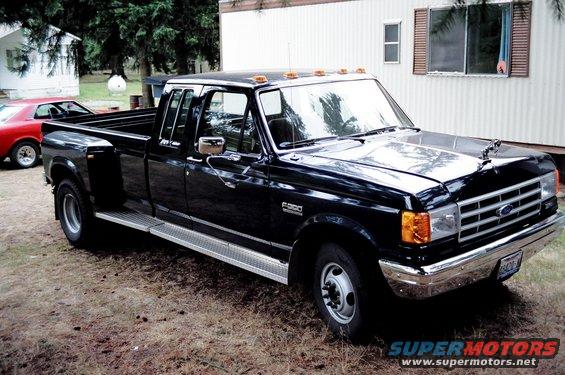 Black crew cab dually pickup truck parked outdoors