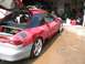 1994 Ford Probe - A red 1994 Ford Probe is shown in a garage with its rear hatch open, revealing interior work and body repair in progress.