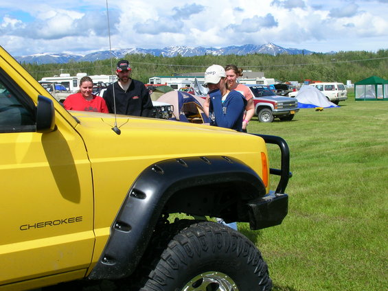 Yellow Jeep Cherokee with fender flares and large tires