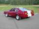 1976 Ford Mustang II - This 1976 Ford Mustang II Cobra II features a distinctive red paint job with white racing stripes and a roll cage visible through the rear…