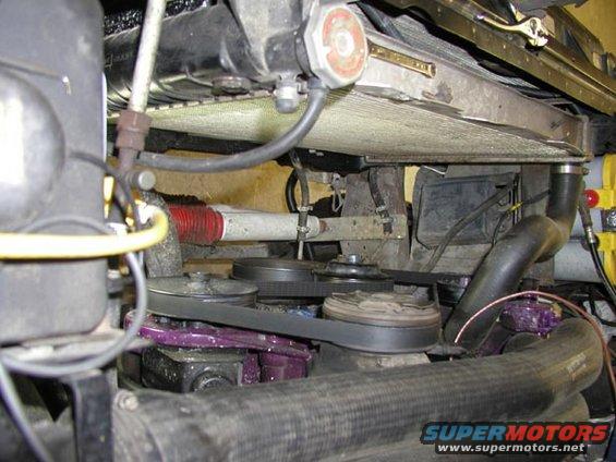 Engine bay showing radiator, belts, and pulleys