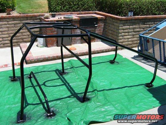 Black roll cage on green tarp