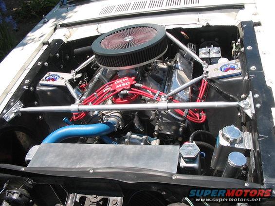 Engine bay showing V8 engine, red MSD ignition wires, chrome valve covers, and large air filter. Blue hose visible