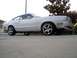 1978 Ford Mustang II - A white coupe with a distinctive fastback profile and aftermarket wheels is parked on a concrete surface.