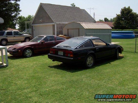 Black 1984 Nissan 300ZX rear 3/4 view, parked next to a maroon 300ZX