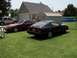 1984 Nissan 300ZX - Two 1984 Nissan 300ZXs are parked in a residential yard, one black and one maroon.
