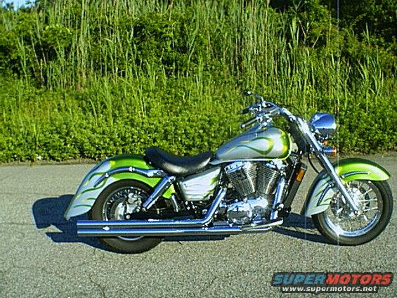 Silver and green motorcycle with flame graphics, side view