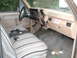 1979 Ford Bronco - Interior of a pickup truck, likely from the early 1980s, with a patterned seat cover and dashboard.