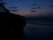 1999 Ford Explorer - A vehicle sits on the sand as waves crash on the shore under a twilight sky.