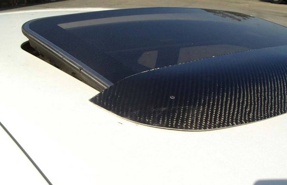 Sunroof with carbon fiber trim on white vehicle