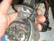 1986 Ford Mustang - Close-up of a car's distributor assembly, held by a hand, with electrical connectors and wires visible.