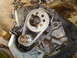 1986 Ford Mustang - Close-up view of an engine's timing chain and gears, with a visible casting number '67' on the block.