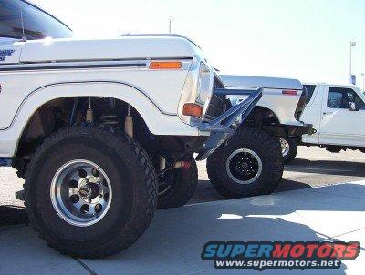 White 1978 Ford Bronco with custom bumper and large tires