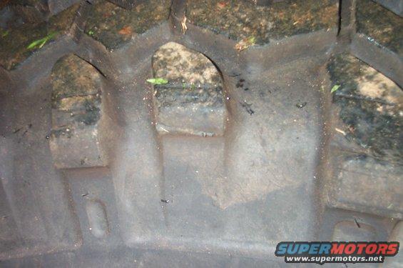 Close-up of a tire tread with mud and debris in the grooves