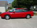 1993 Ford Probe - A red 1993 Ford Probe is parked in a suburban driveway on a sunny day.