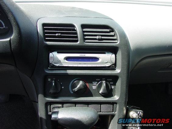 Car dashboard with aftermarket stereo, air vents, and climate controls