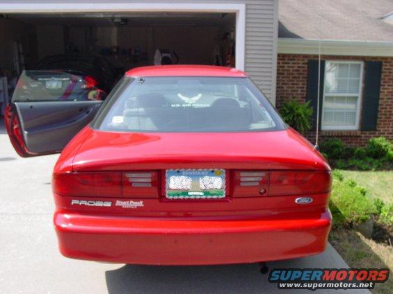 Red 1993 Ford Probe rear view with driver's door open