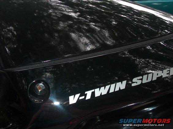 Black motorcycle with V-TWIN SUPER text on its side