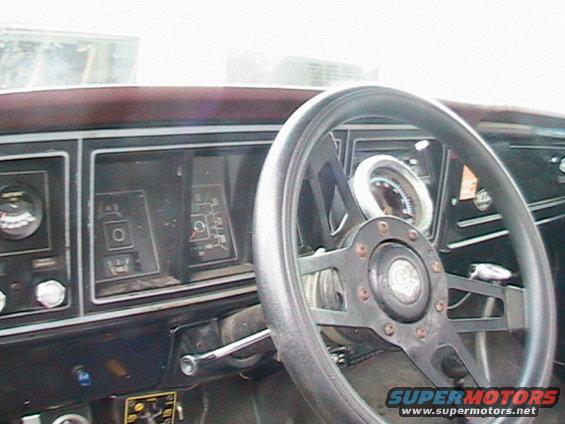 Dashboard of a 1977 Ford F-250 with a black steering wheel and gauges