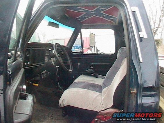 1977 Ford F-250 interior showing dashboard, steering wheel, seat, and Confederate flag headliner